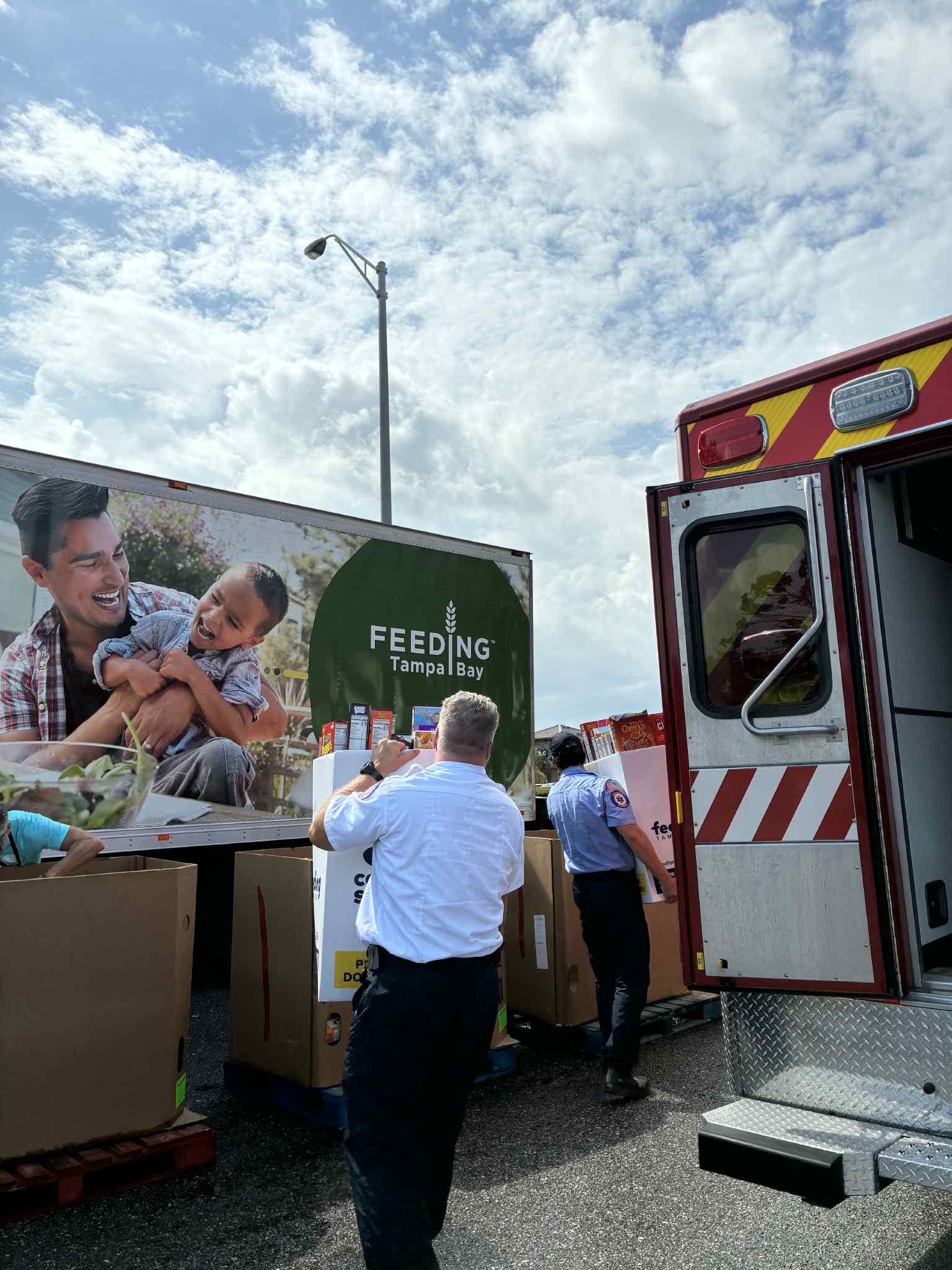 Two Firefighters dropping of Cereal for Summer Donations 